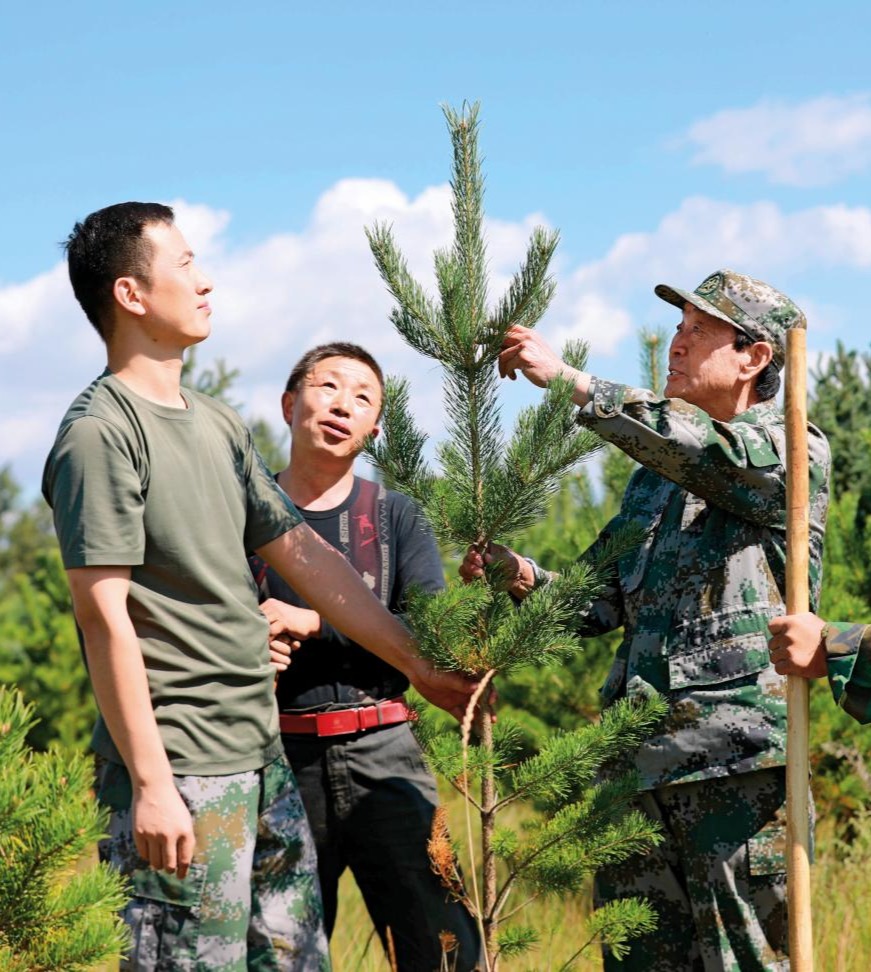 2021-08-26，張連印帶著貧困戶魏隨舍和教育基地工作人員種樹(shù)。（丁美寧 攝）